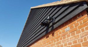 aston martin cctv surveillance security and speaker installed on the building
