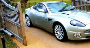 Aston Martin car driving through automated gate