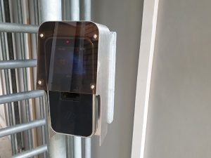 installation of biometric reader with rain proof cover inside hoarding entrance