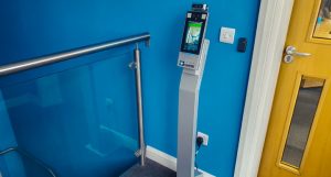 Freestanding temperature scanner to monitor personnel temperature on arrival